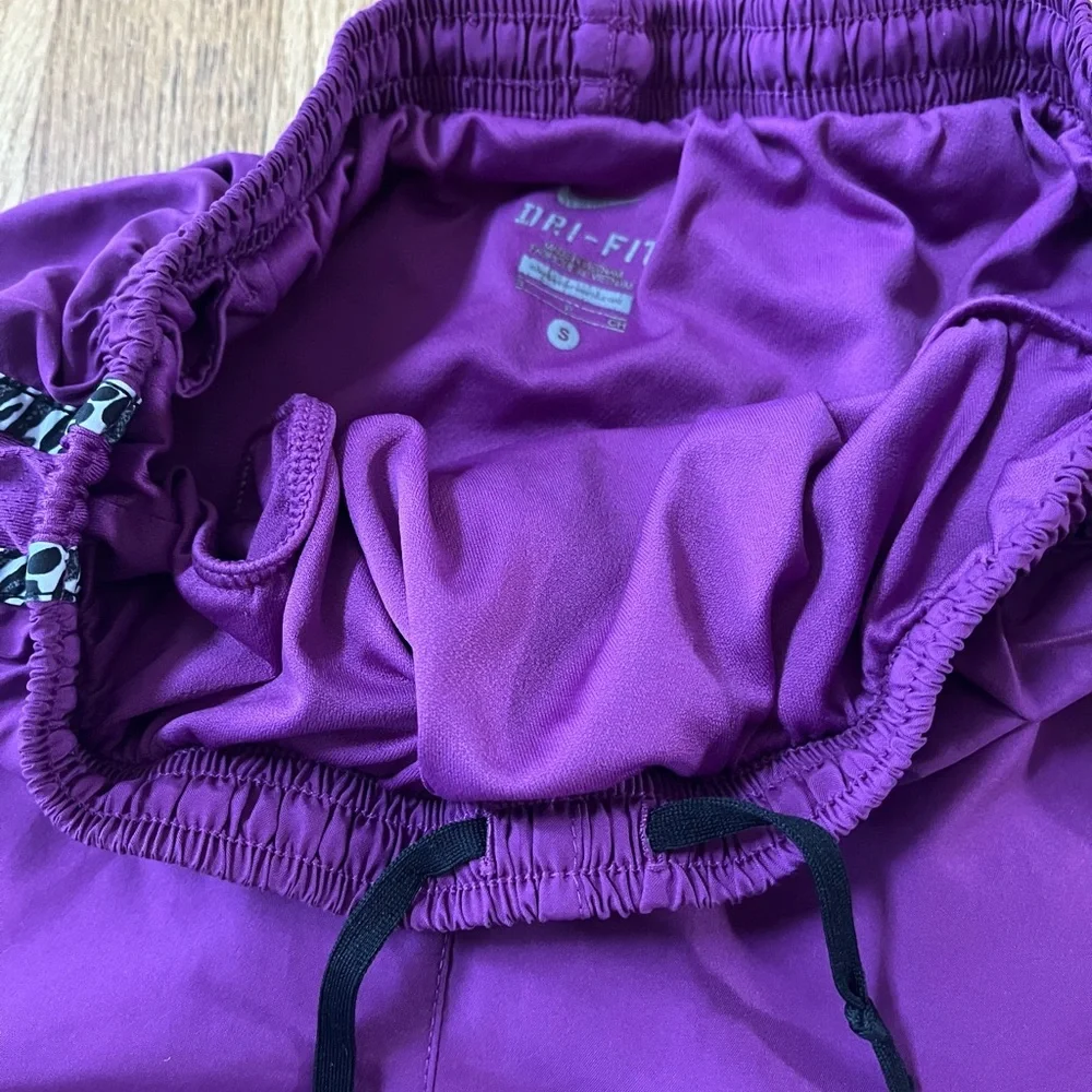 Women’s purple Dri-Fit Nike running shorts with animal print